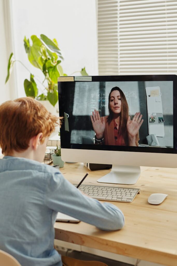 zipwp-image-4145196 Photo of Boy Video Calling With a Woman Through Imac