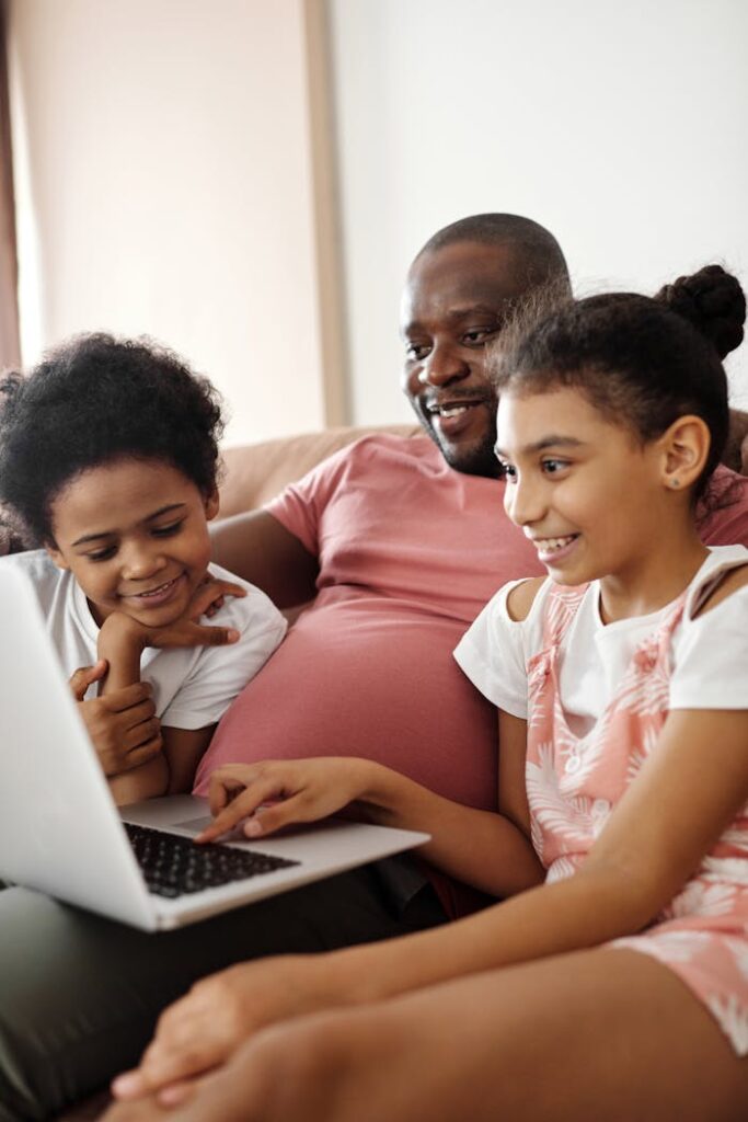 zipwp-image-4260753 Happy Family Sitting and Looking at a Laptop